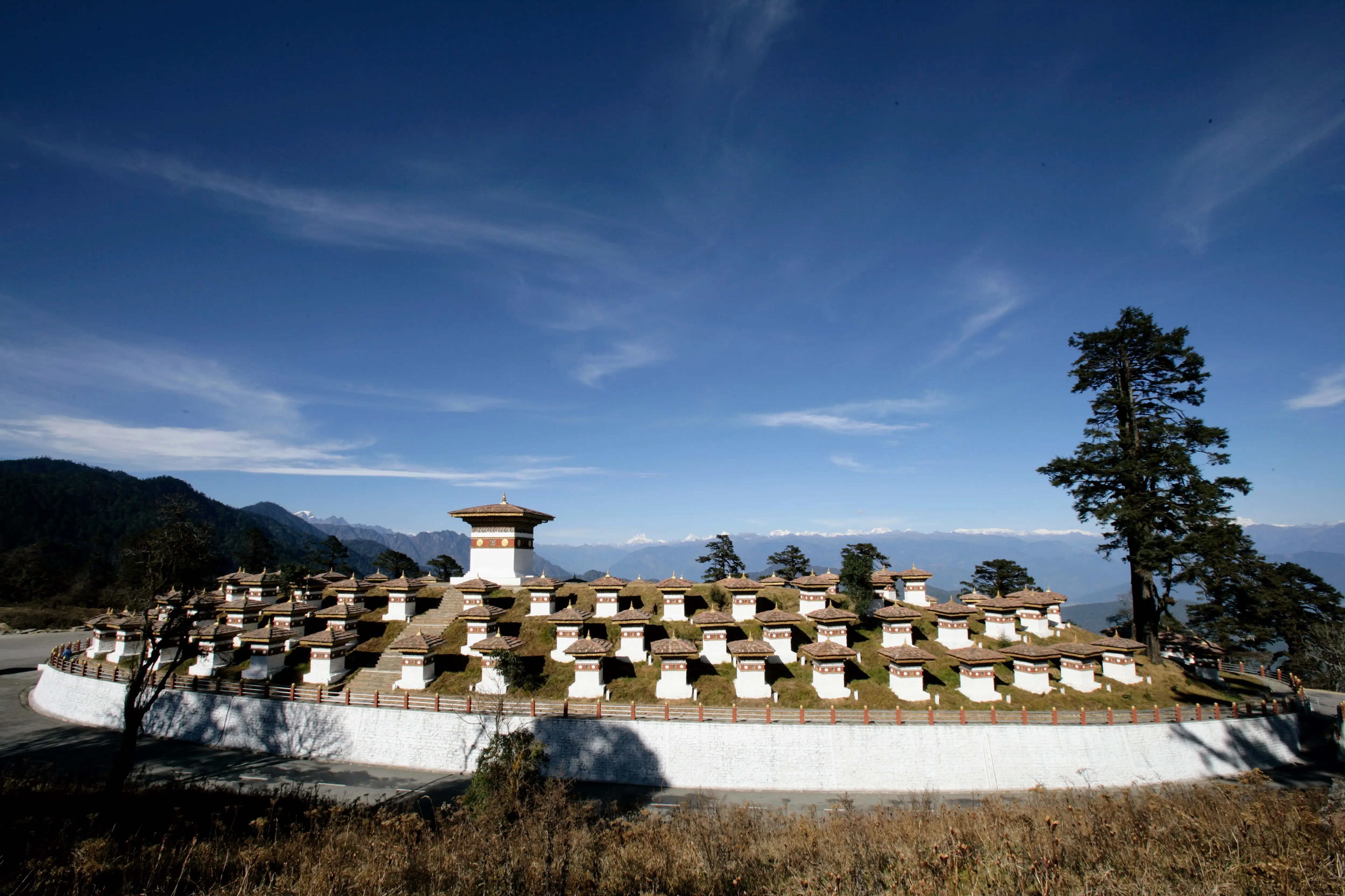 The 108 Druk Wangyal chortens at Dochula under a clear autumn sky, the Himalaya on the horizon