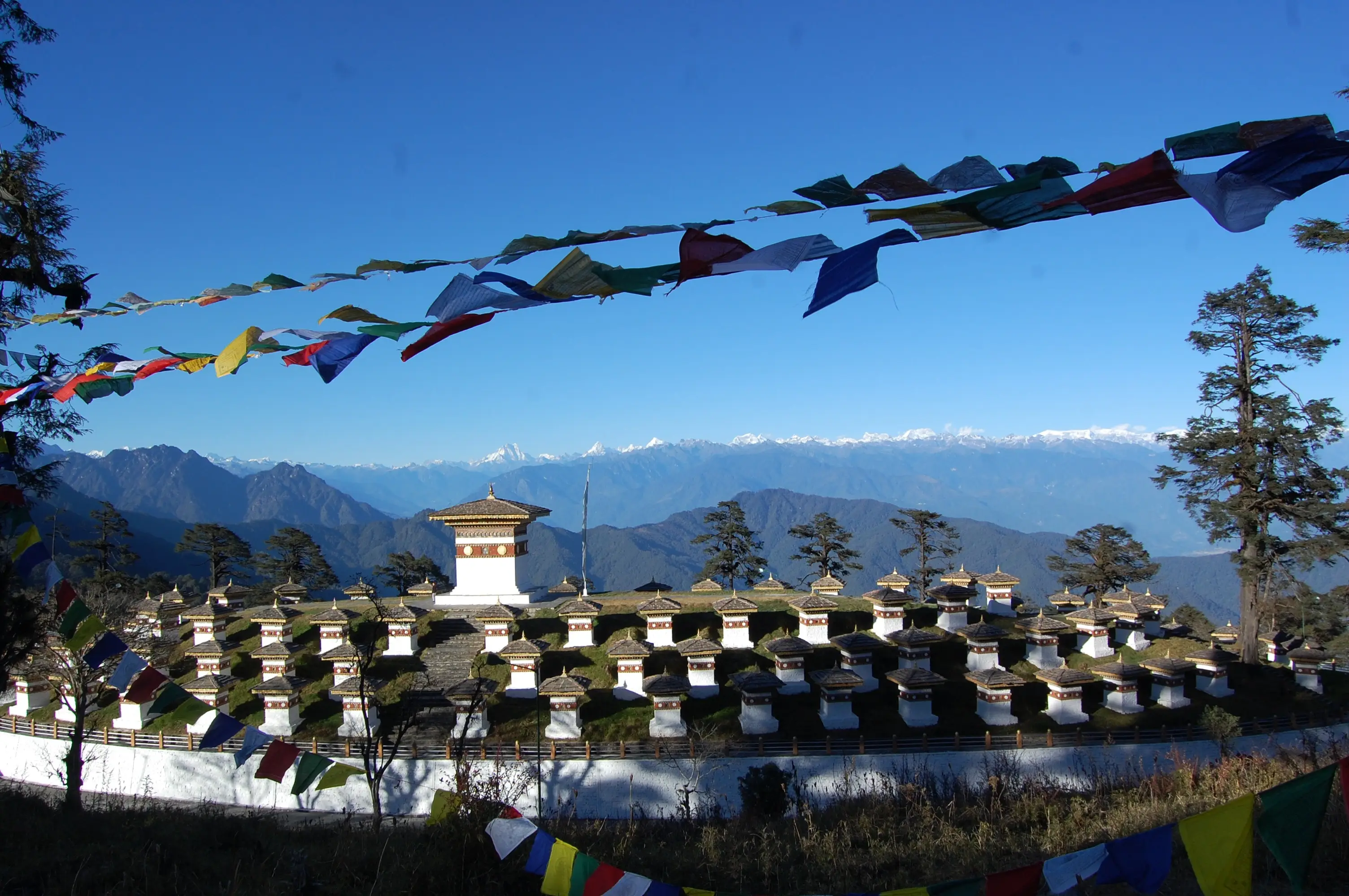 Himalayan peaks in clear air beyond the chortens of Dochula pass